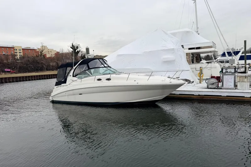 Slide: The Image of 2007 Sea Ray Sundancer 320 docked at a marina on a cloudy day. - 2