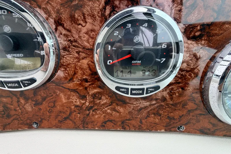 Slide: The Image of Dashboard of a 2007 Sea Ray Sundancer 320 showing RPM and speed gauges. - 21