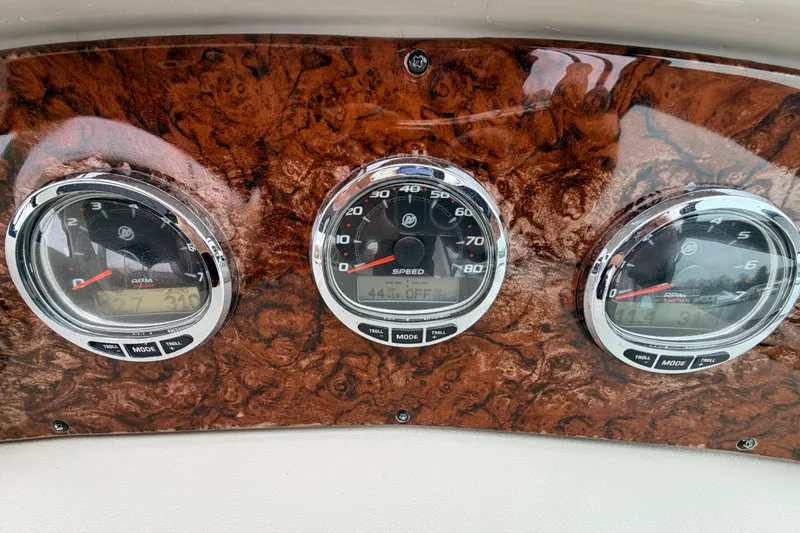 Slide: The Image of Dashboard of a 2007 Sea Ray Sundancer 320 with speed and RPM gauges. - 23