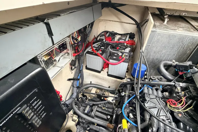 Slide: The Image of Engine compartment of a 2007 Sea Ray Sundancer 320 with batteries and wiring visible. - 28