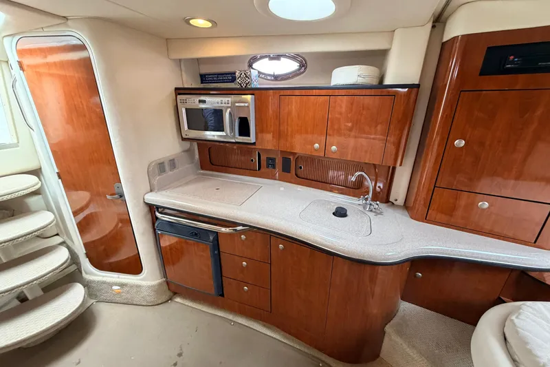 Slide: The Image of Interior of a 2007 Sea Ray Sundancer 320 yacht with kitchenette and wooden cabinetry. - 33