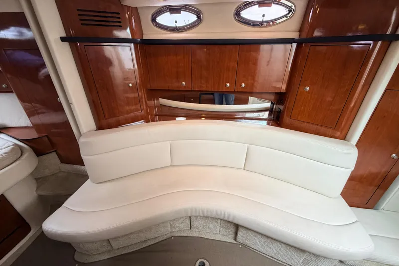 Slide: The Image of Luxurious interior of 2007 Sea Ray Sundancer 320 with curved seating and wooden cabinetry. - 36
