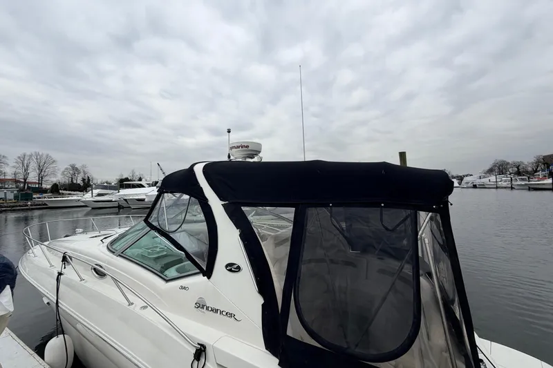 Slide: The Image of 2007 Sea Ray Sundancer 320 docked at a marina under cloudy skies. - 6