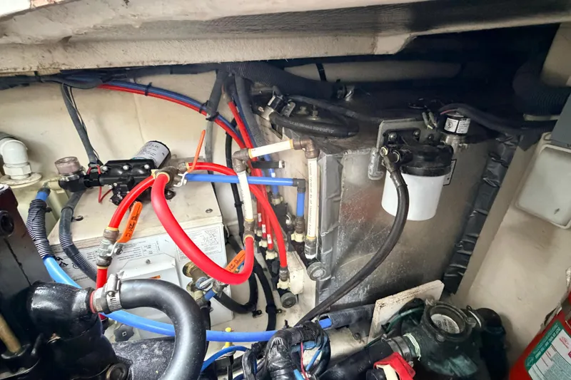 Slide: The Image of Engine compartment of a 2007 Sea Ray Sundancer 320 with visible wiring and components. - 7