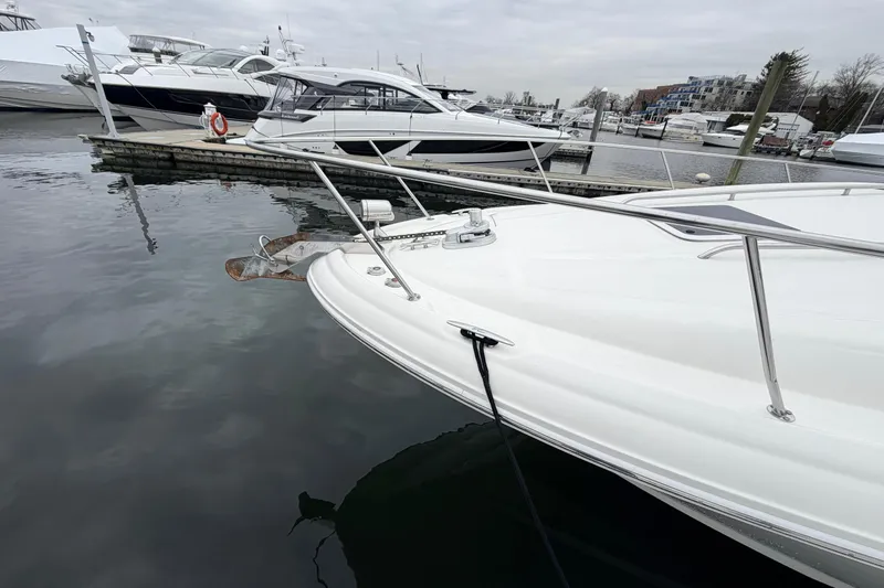 Slide: The Image of 2007 Sea Ray Sundancer 320 docked at a marina, showcasing sleek design and water reflections. - 8