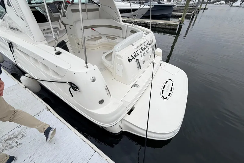 Slide: The Image of 2007 Sea Ray Sundancer 320 docked, showcasing sleek design and spacious deck area. - 9