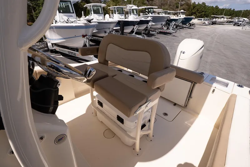 Slide: The Image of 2026 Scout 215 XSF boat interior with helm seat and steering wheel. - 11