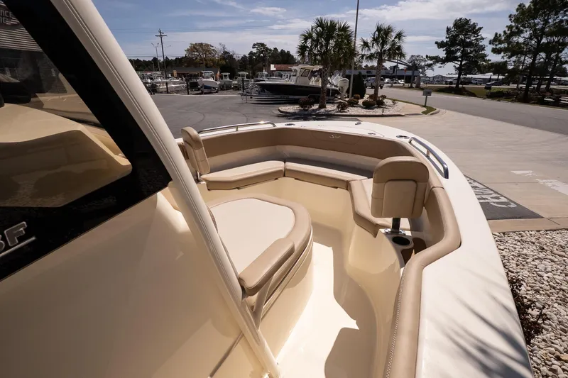 Slide: The Image of 2026 Scout 215 XSF boat interior with beige seating and cup holders. - 13