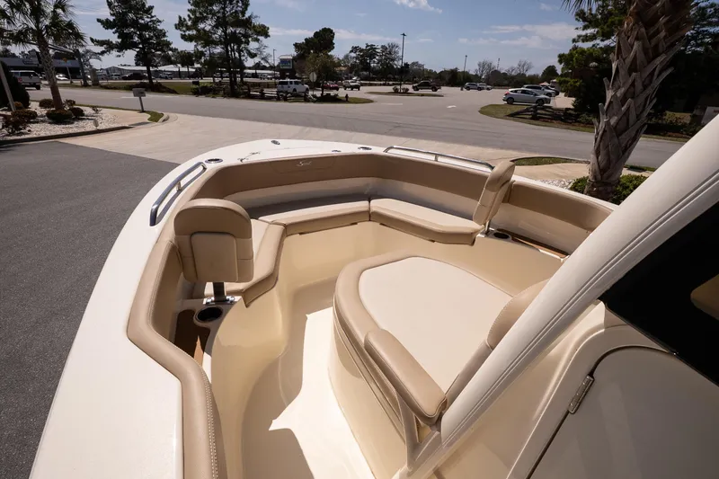 Slide: The Image of 2026 Scout 215 XSF boat interior with beige seating and cup holders. - 14