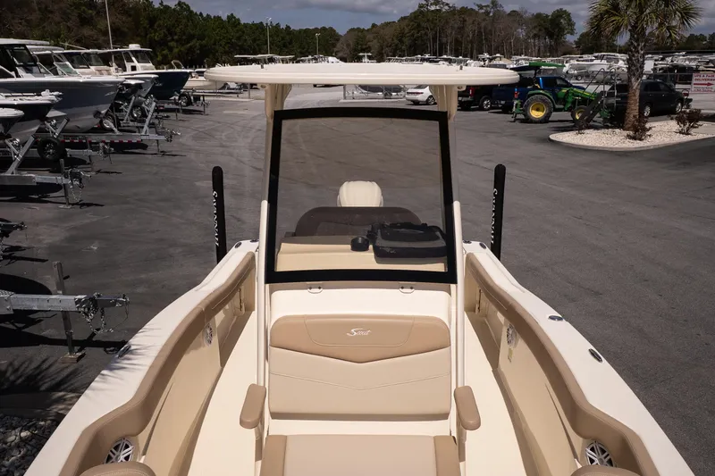 Slide: The Image of 2026 Scout 215 XSF boat displayed in a dealership lot under clear skies. - 16