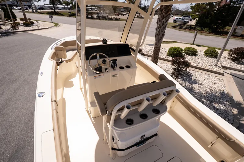 Slide: The Image of 2026 Scout 215 XSF boat interior with helm, seating, and rod holders. - 9