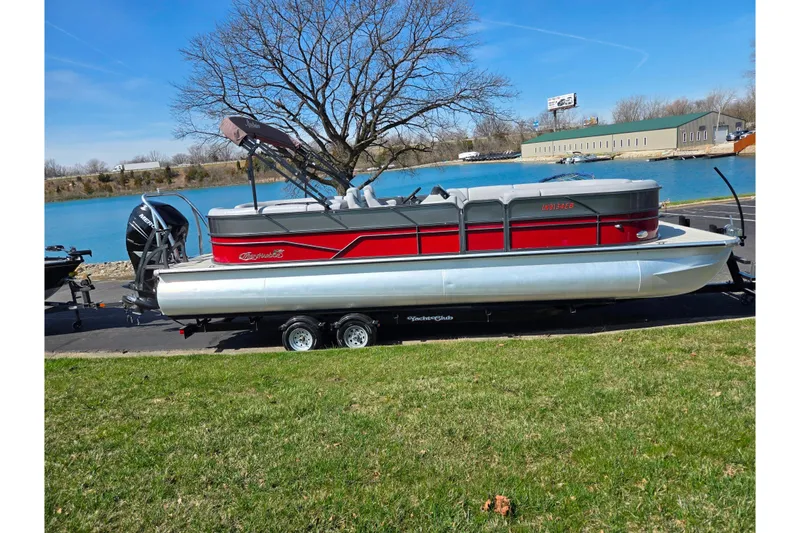 Slide: The Image of 2018 Misty Harbor 2585 Biscayne Bay CU pontoon boat on trailer by a lake. - 10