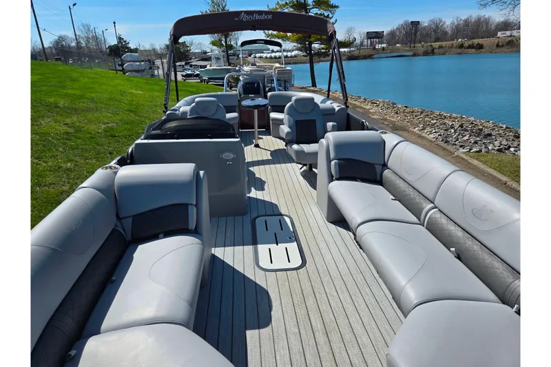 Slide: The Image of 2018 Misty Harbor 2585 Biscayne Bay CU pontoon boat with spacious seating by a serene lake. - 12