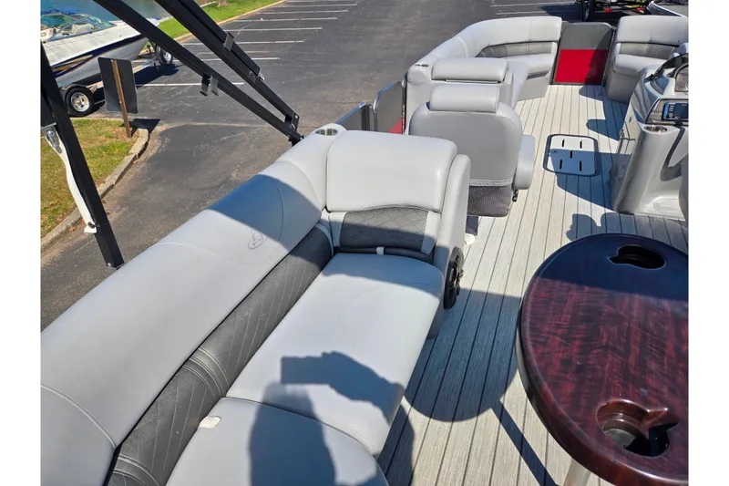 Slide: The Image of 2018 Misty Harbor 2585 Biscayne Bay CU pontoon boat interior with gray seating and wood table. - 21