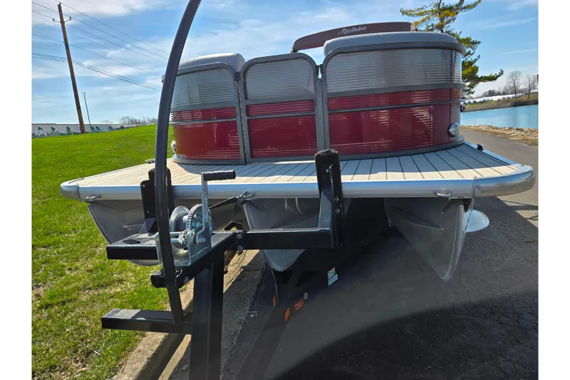 Slide: The Image of 2018 Misty Harbor 2585 Biscayne Bay CU pontoon boat on trailer, parked near a lake. - 6