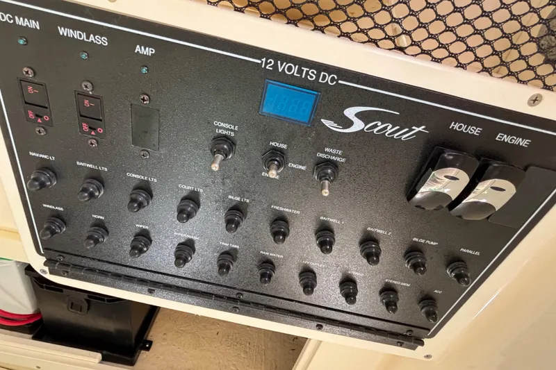 Slide: The Image of Control panel of a 2016 Scout 255 LXF boat with various switches and indicators. - 15