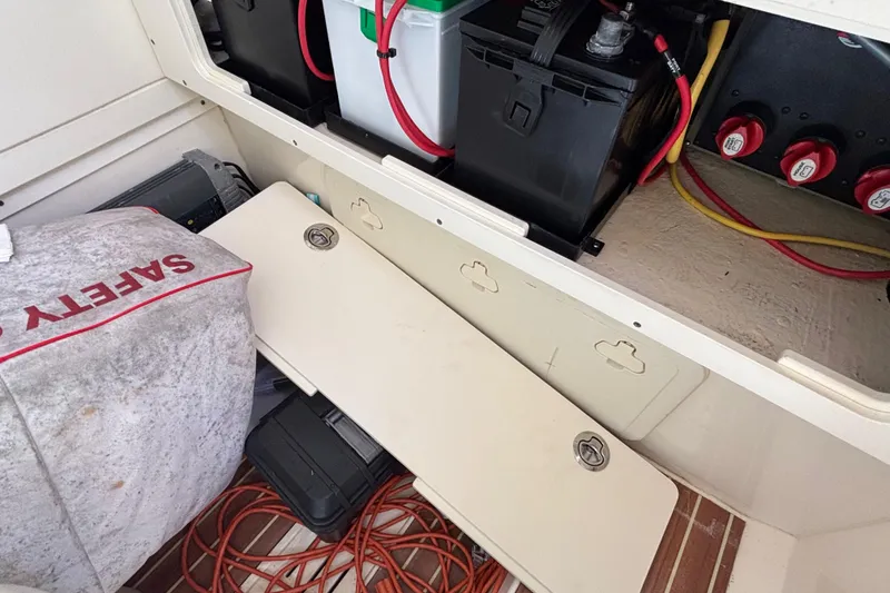 Slide: The Image of Interior view of a 2016 Scout 255 LXF boat showing battery compartment and safety equipment. - 16