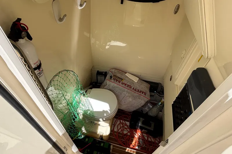 Slide: The Image of Interior of a 2016 Scout 255 LXF boat with storage items and equipment. - 19