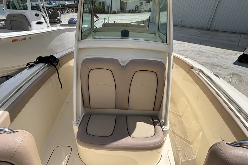 Slide: The Image of 2016 Scout 255 LXF boat interior with cushioned seating and helm station. - 23