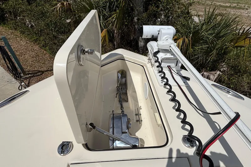 Slide: The Image of 2016 Scout 255 LXF boat anchor compartment with open hatch and wiring. - 28