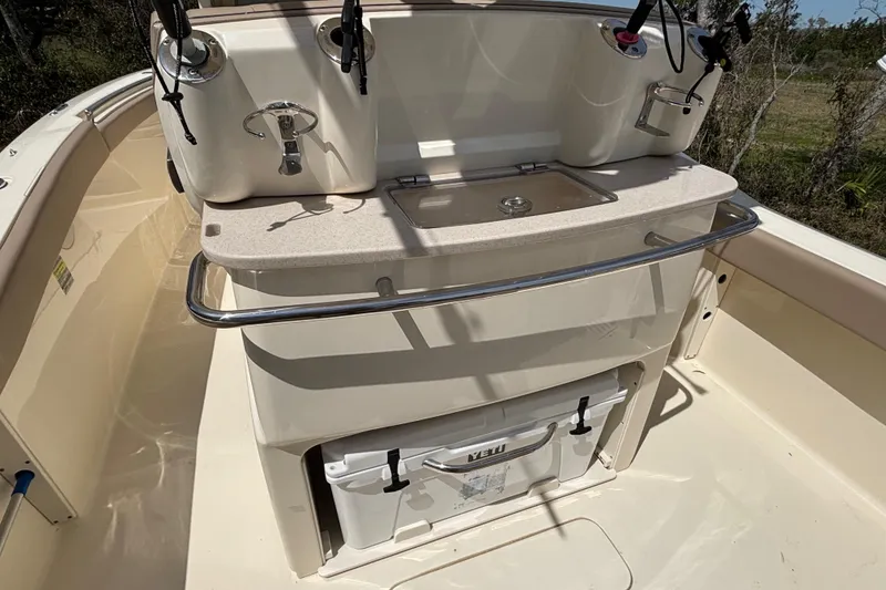 Slide: The Image of 2016 Scout 255 LXF boat interior with fishing rod holders and storage compartment. - 3