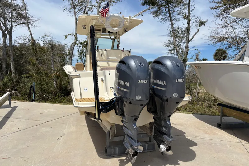 Slide: The Image of 2016 Scout 255 LXF boat with dual Yamaha 150 engines on display. - 32
