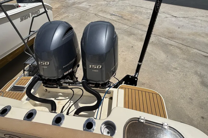 Slide: The Image of Twin Yamaha 150 engines on a 2016 Scout 255 LXF boat, docked on concrete. - 6