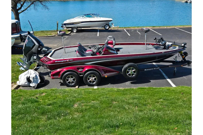 The Image of 2018 Ranger Z520 Comanche Cup-Equipped boat parked near a lake on a trailer. - 0