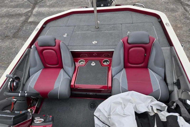 Slide: The Image of 2018 Ranger Z520 Comanche boat interior with red and gray seats, cup holders, and storage. - 21