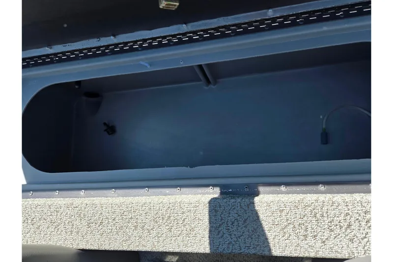 Slide: The Image of 2021 G3 Sportsman 1810 boat storage compartment, open and empty, with visible interior details. - 25