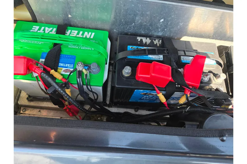 Slide: The Image of Two batteries in a 2021 G3 Sportsman 1810 boat, secured with straps. - 26