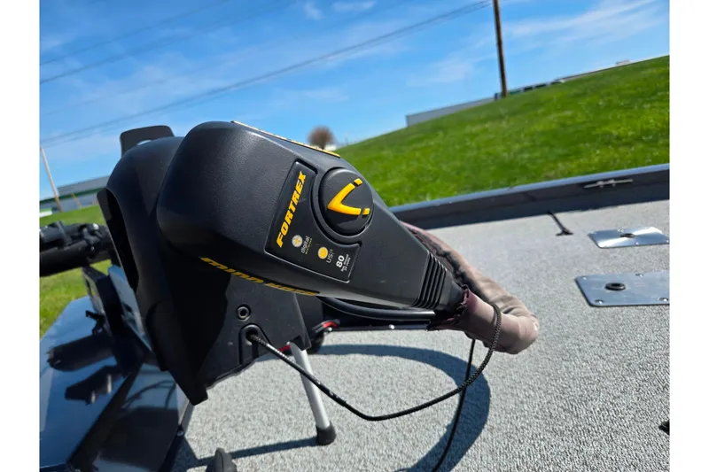 Slide: The Image of Trolling motor on 2021 G3 Sportsman 1810 boat, sunny day, grassy background. - 6