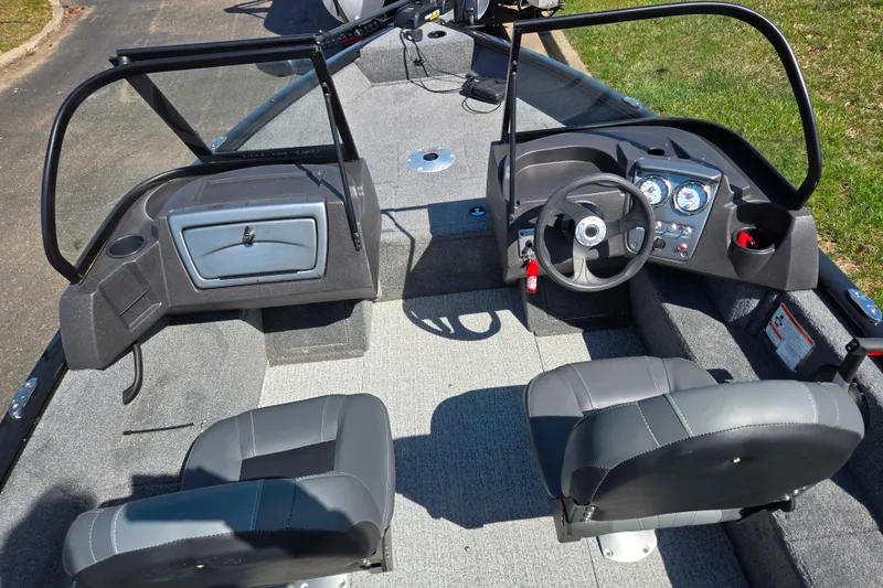 Slide: The Image of 2024 Tracker Pro Guide V-16 WT boat interior with dual seats and steering console. - 11
