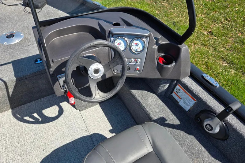 Slide: The Image of 2024 Tracker Pro Guide V-16 WT boat dashboard with steering wheel and gauges. - 12