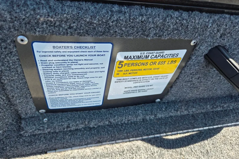 Slide: The Image of 2024 Tracker Pro Guide V-16 WT boat safety checklist and capacity label. - 13