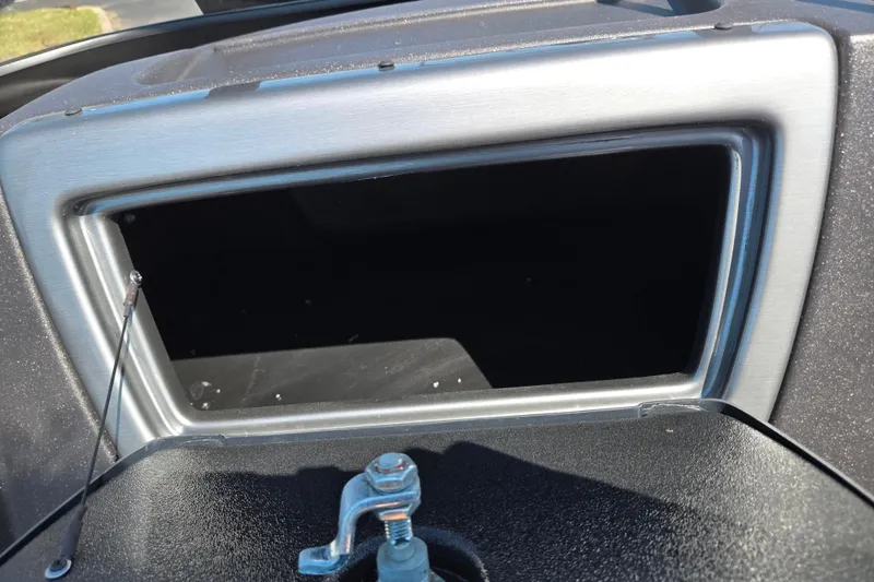 Slide: The Image of 2024 Tracker Pro Guide V-16 WT dashboard compartment with open storage space. - 15