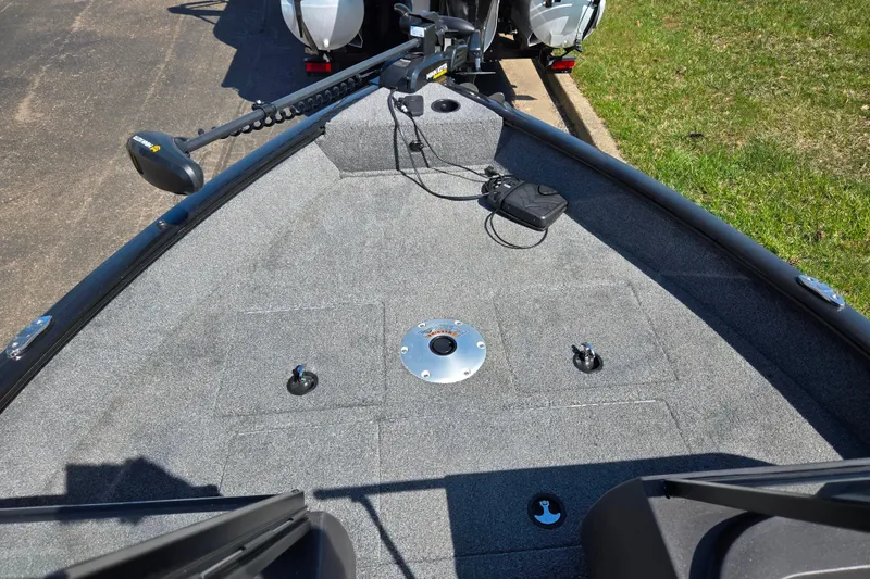 Slide: The Image of 2024 Tracker Pro Guide V-16 WT boat deck with trolling motor and storage compartments. - 16