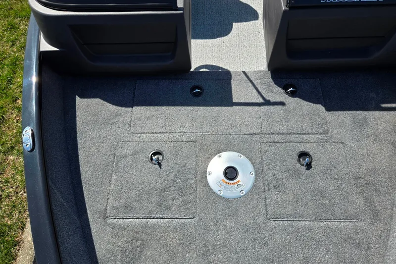 Slide: The Image of 2024 Tracker Pro Guide V-16 WT boat interior with carpeted deck and storage compartments. - 20