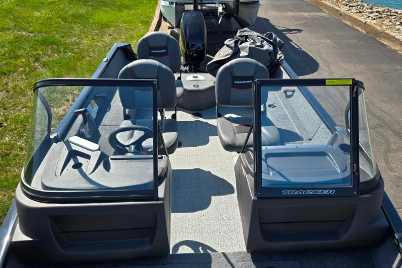 Slide: The Image of 2024 Tracker Pro Guide V-16 WT boat interior with seating and windshield. - 21
