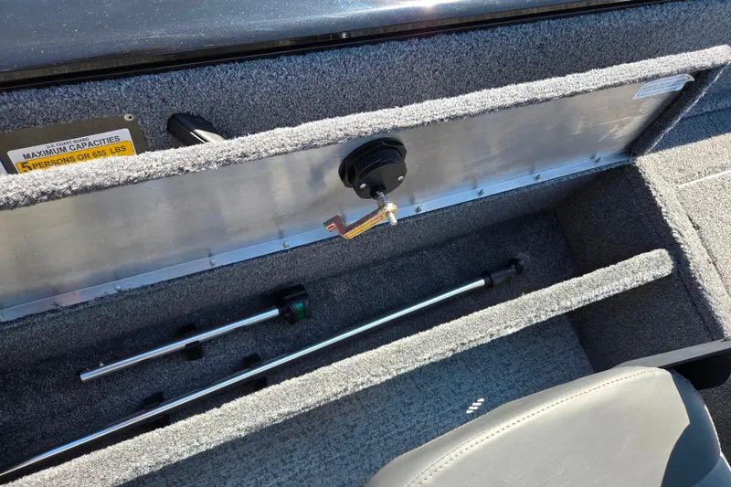 Slide: The Image of 2024 Tracker Pro Guide V-16 WT boat interior storage compartment with capacity label. - 24