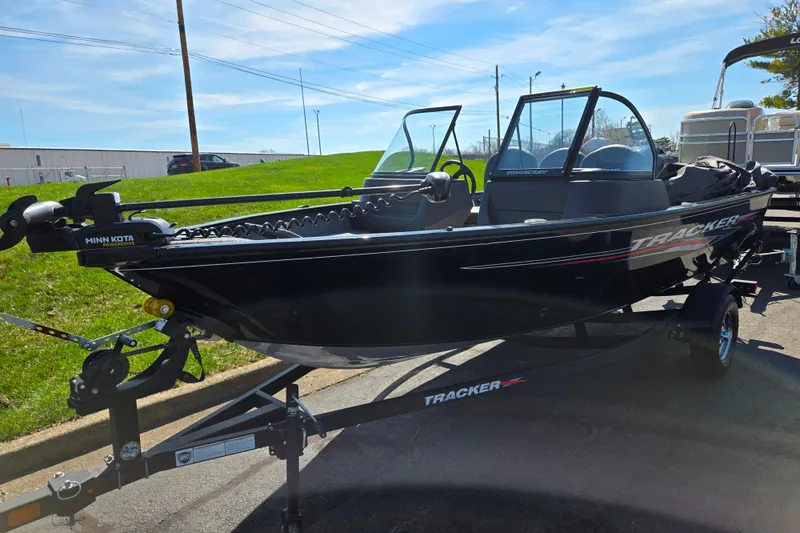 Slide: The Image of 2024 Tracker Pro Guide V-16 WT boat on trailer, featuring Minn Kota trolling motor. - 6