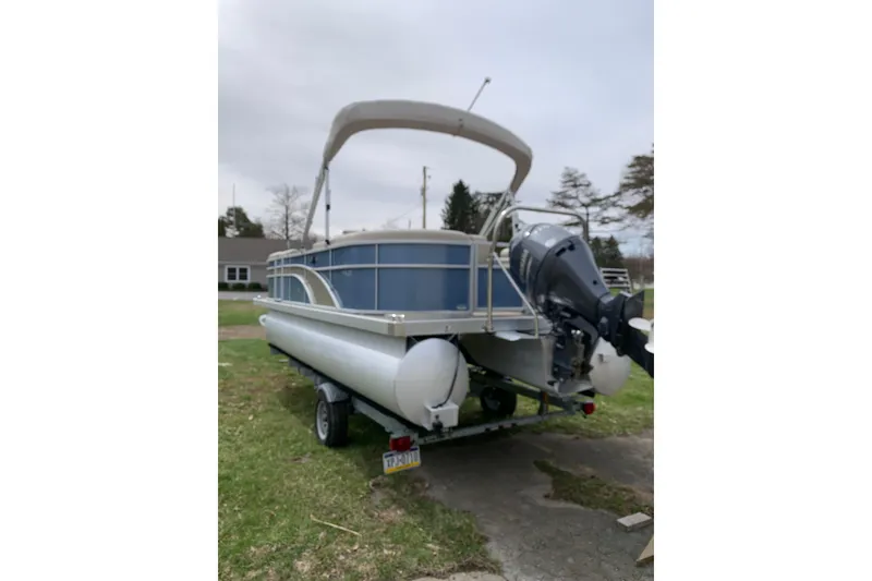 Slide: The Image of 2018 Bennington pontoon boat with canopy and outboard motor on trailer. - 4
