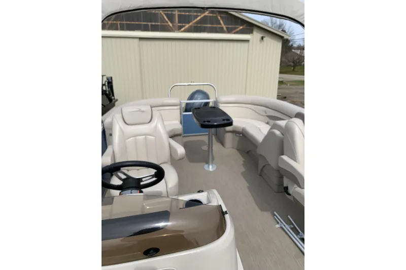 Slide: The Image of 2018 Bennington boat interior with beige seating and steering wheel. - 6