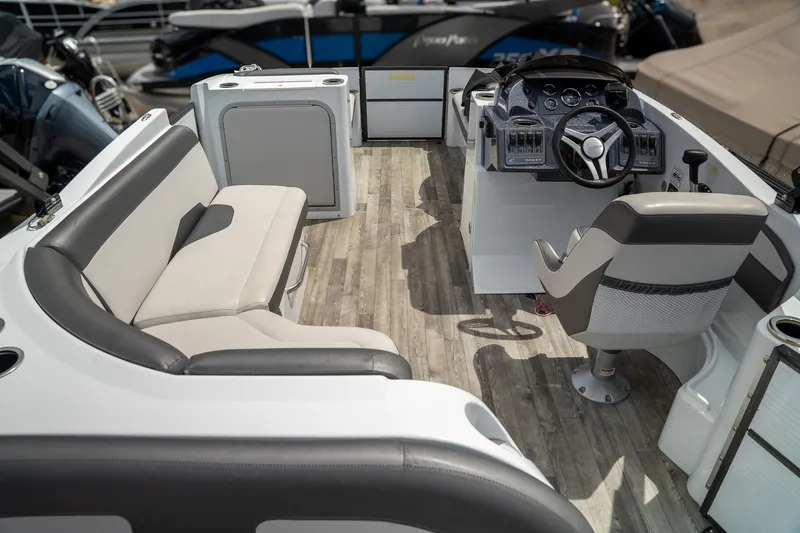 Slide: The Image of Interior of a 2018 Crest Calypso 190 SL boat with steering wheel and seating area. - 3