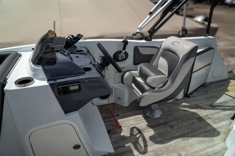 Slide: The Image of Interior of a 2018 Crest Calypso 190 SL boat with steering console. - 6