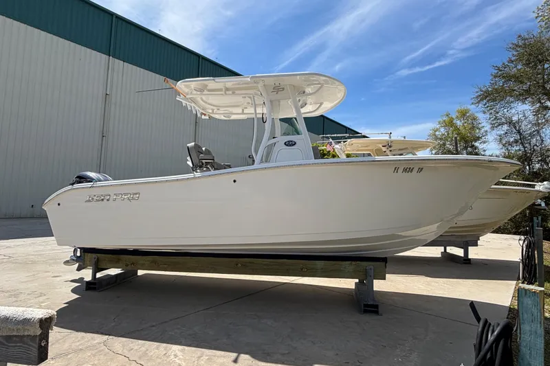 The Image of 2023 Sea Pro 239 Deep V CC boat displayed outdoors on a sunny day. - 0