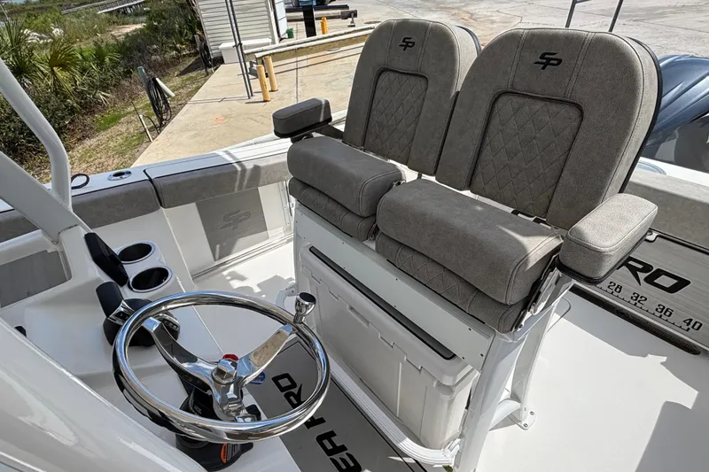 Slide: The Image of 2023 Sea Pro 239 Deep V CC boat interior with dual seats and steering wheel. - 10