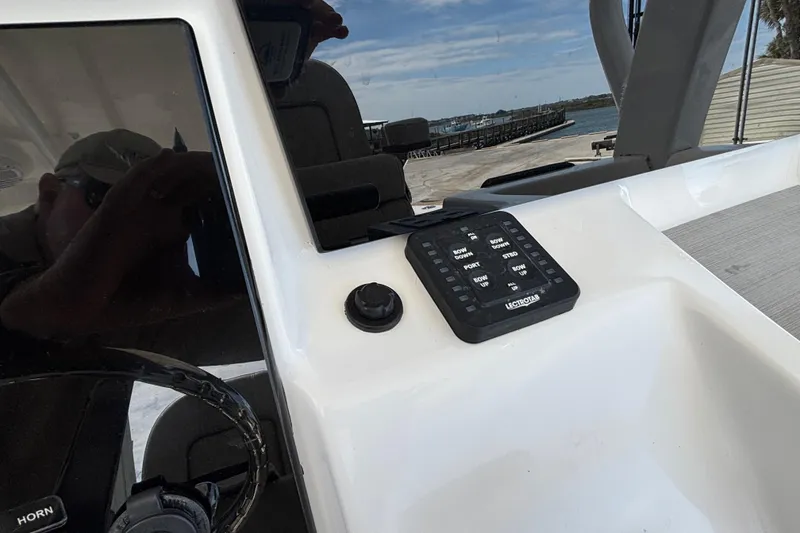 Slide: The Image of 2023 Sea Pro 239 Deep V CC boat console with control panel and steering wheel. - 12