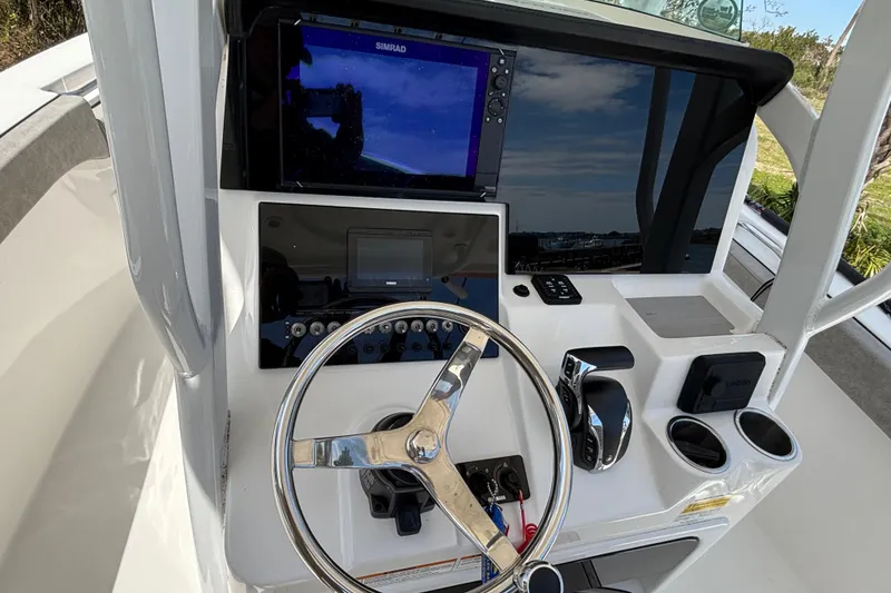 Slide: The Image of 2023 Sea Pro 239 Deep V CC boat console with steering wheel and navigation display. - 13
