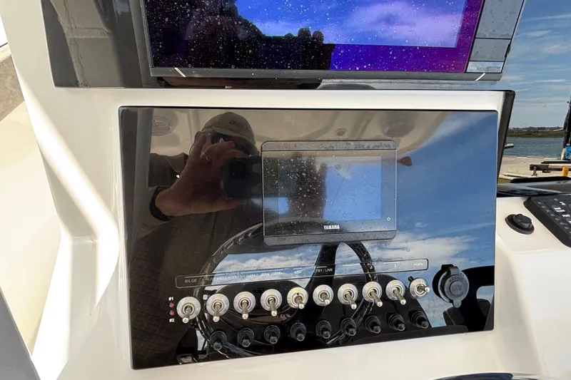 Slide: The Image of 2023 Sea Pro 239 Deep V CC dashboard with Yamaha display and control switches. - 14